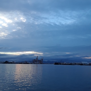 A serene cinematic still of Copenhagen's harbor at dusk, soft light reflecting on calm water.
