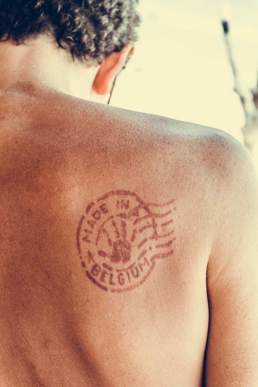 man's shoulder with tattoo