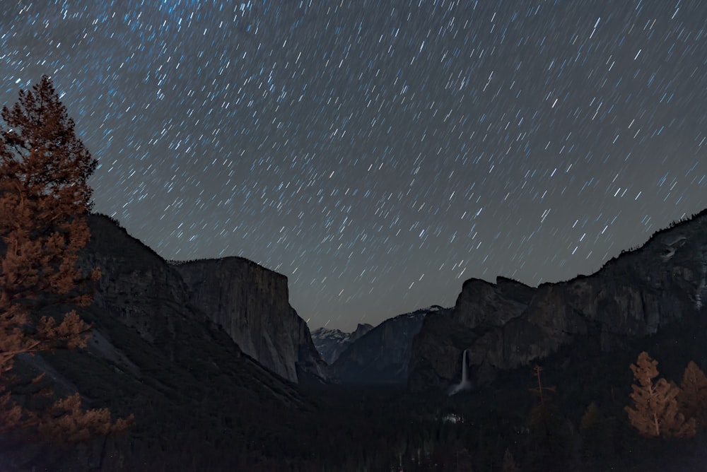 mountain range under starry skies