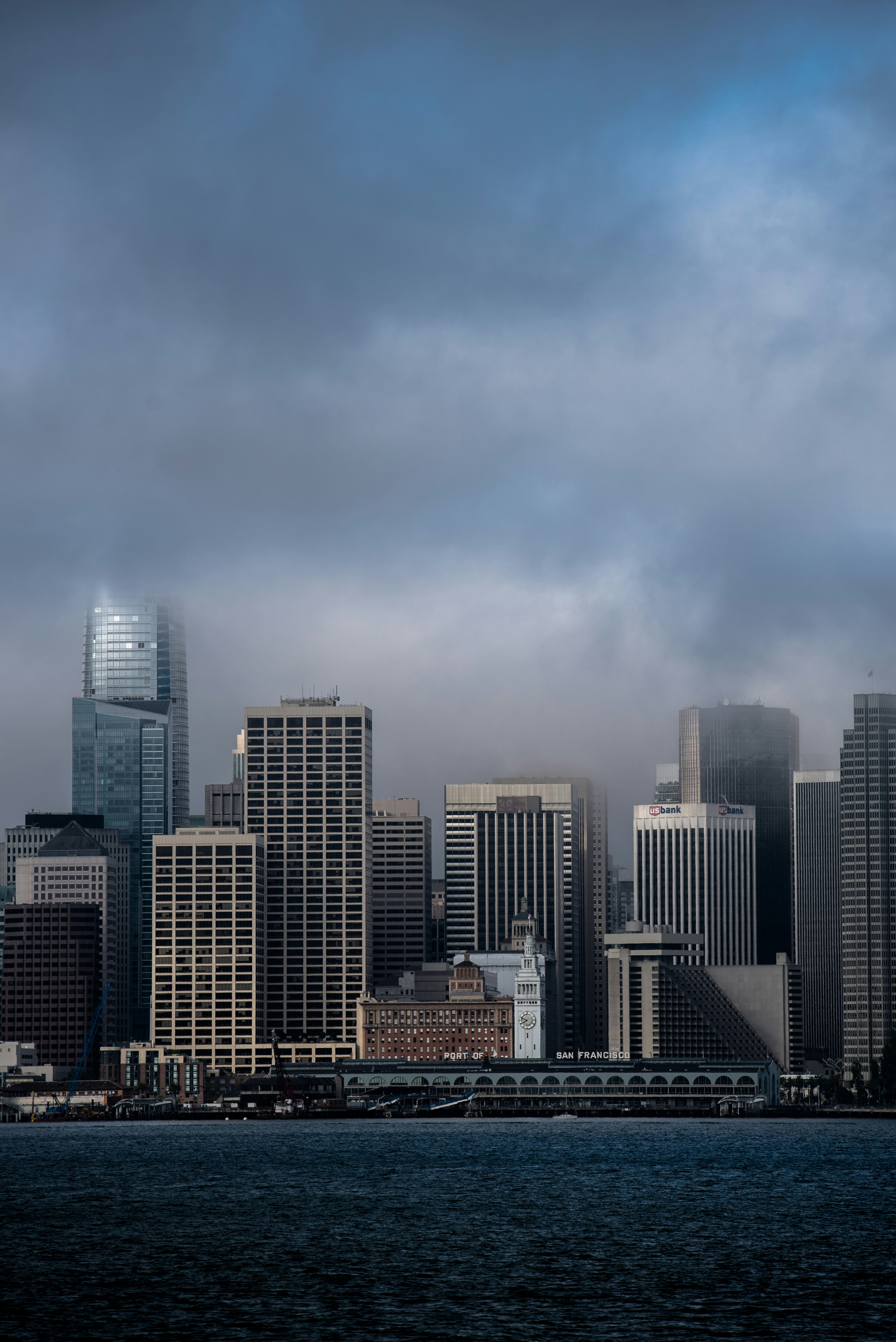 cityscape under dramatic sky during daytime