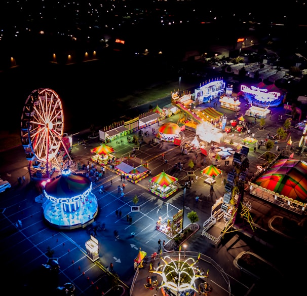 an aerial view of an amusement park at night