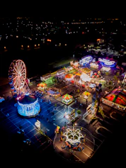 an aerial view of an amusement park at night
