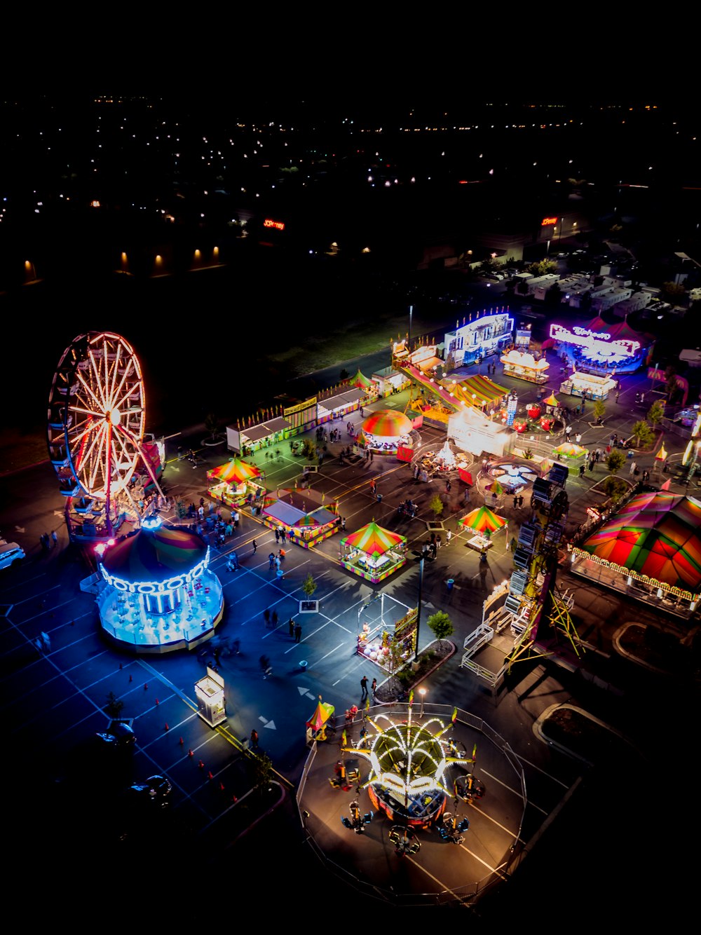 an aerial view of an amusement park at night