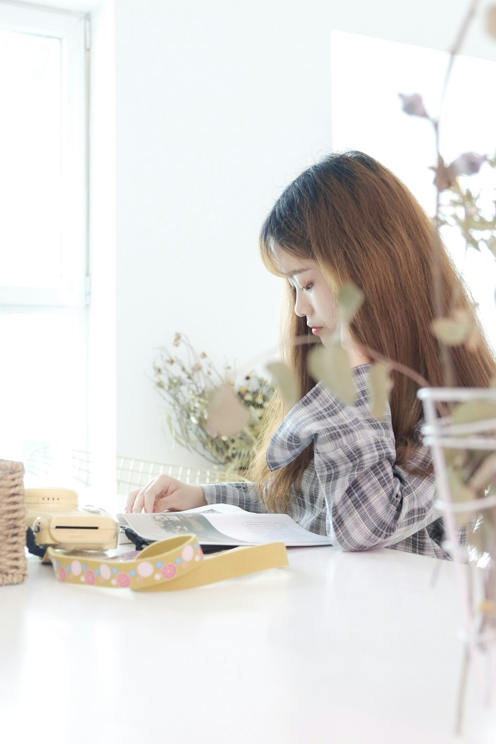 woman reading book at table