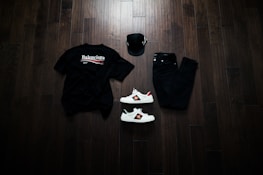 Photo of casual shoes and t-shirts arranged in a clean, modern style.
