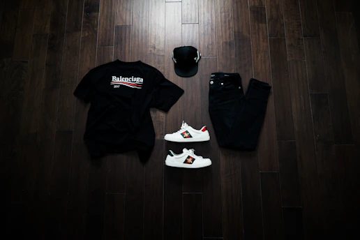 Flat lay of trendy sneakers, caps, and urban fashion items on a concrete background.