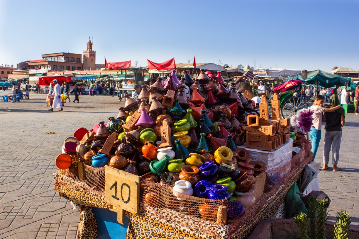 A colorful Moroccan market street filled with spices, textiles, and lively locals.