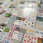 Children playing an interactive educational game with bright cards on a classroom floor