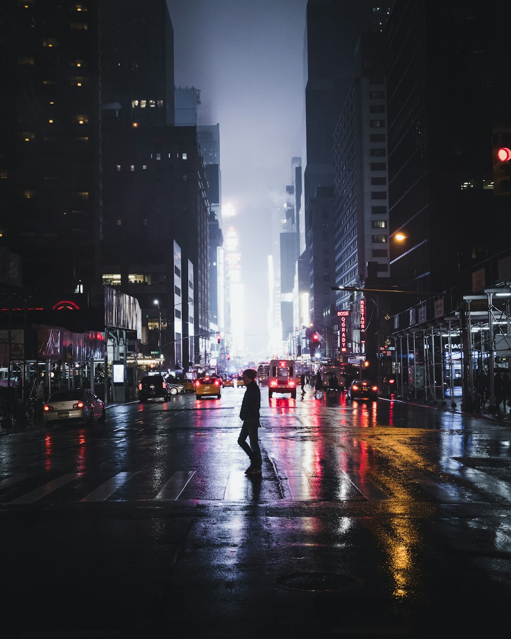 man standing between road