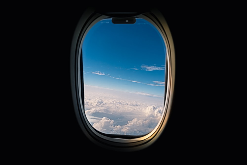 Fenster der Fluggesellschaft mit Blick auf weiße Wolken