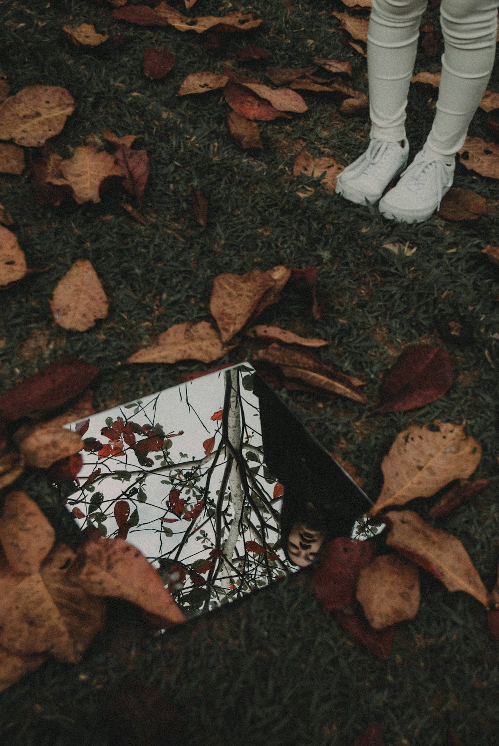 a person standing next to a white umbrella