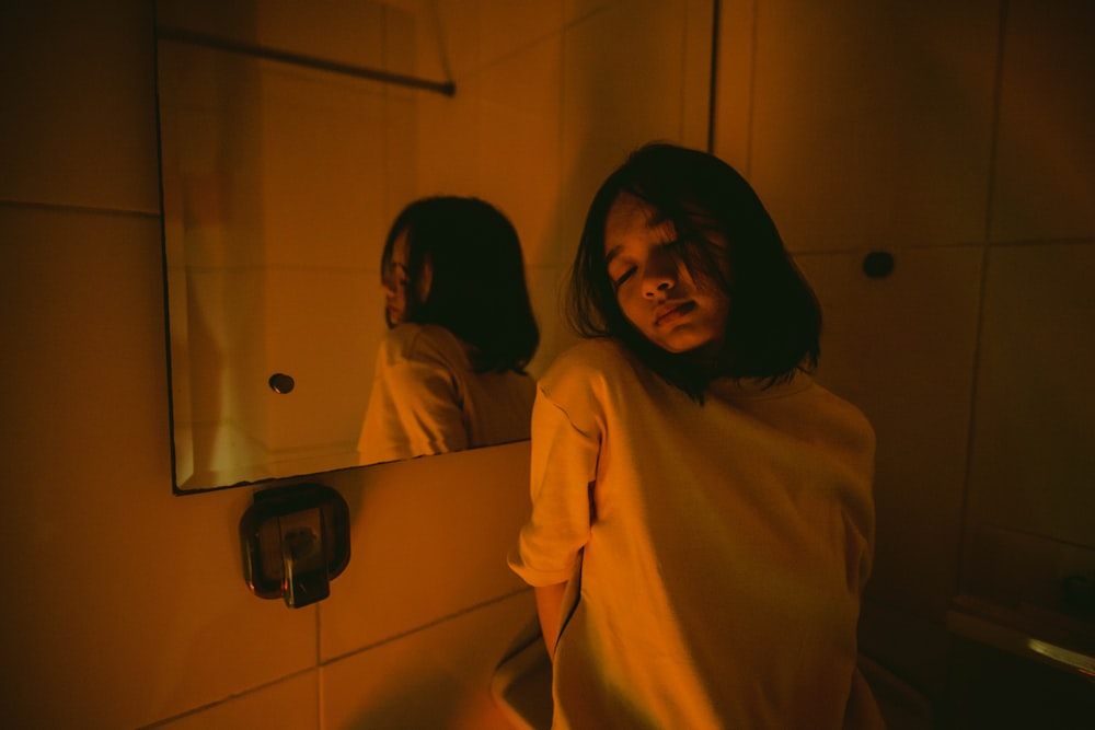 woman standing in front of mirror