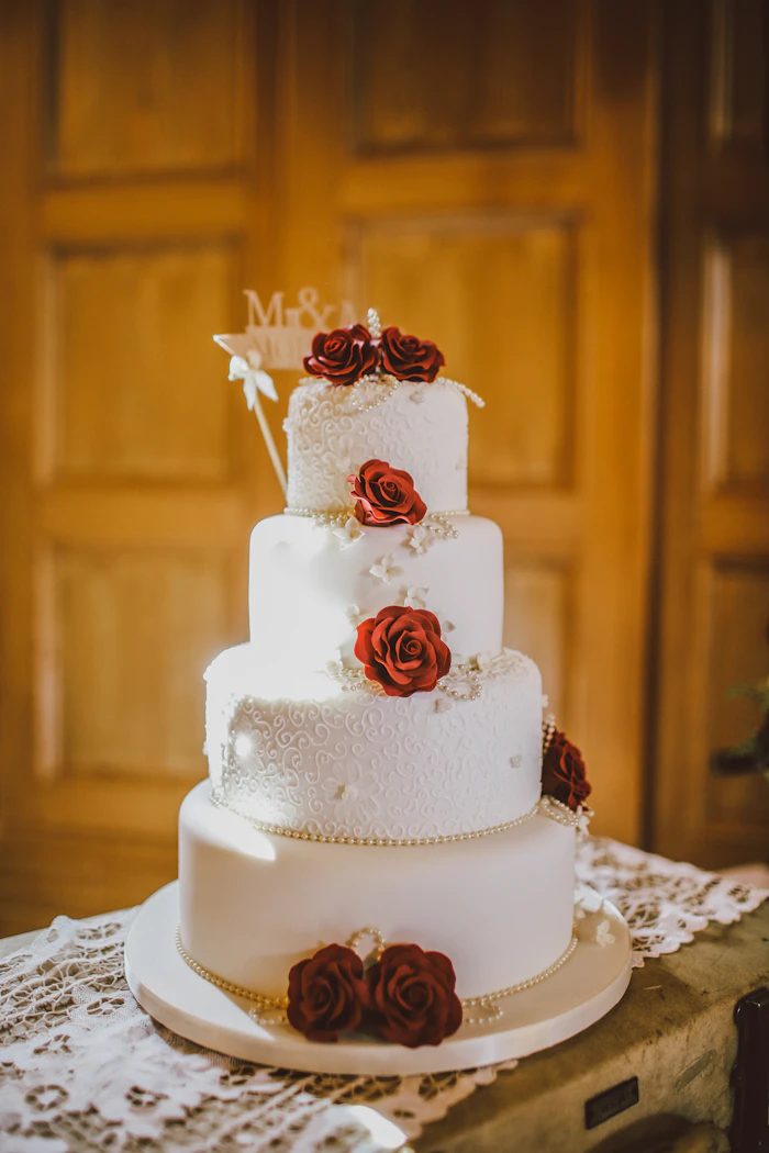 Round white floral four-tier fondant cake