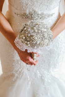 a close up of a person holding a bouquet of flowers