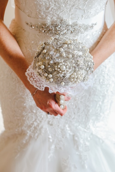 a close up of a person holding a bouquet of flowers