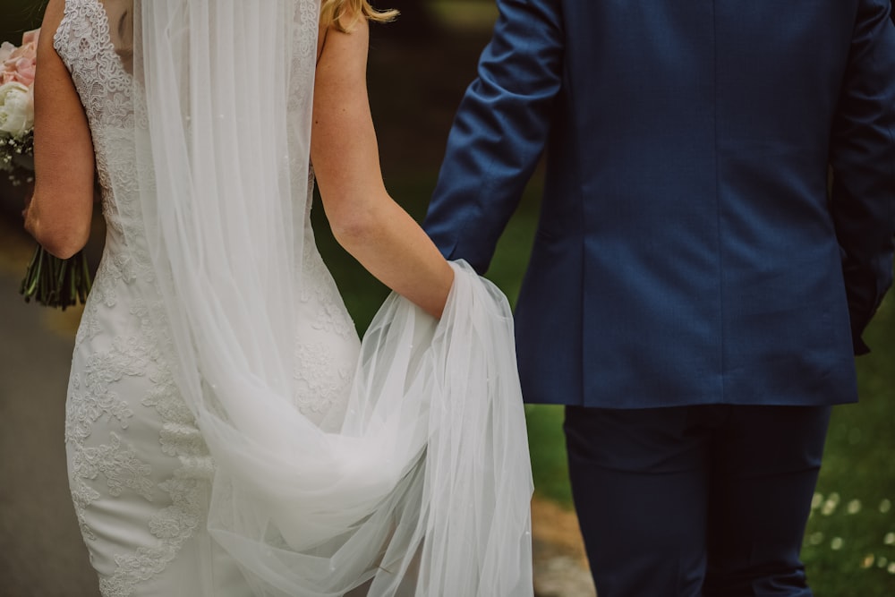 wedding couple holding hands while walking