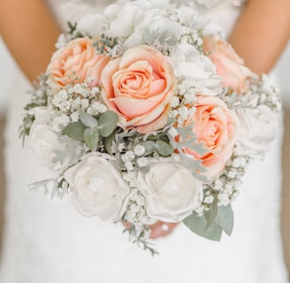 woman holding white and pink rose flower bouquet