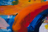 A close-up of a colorful abstract painting with bold brush strokes.