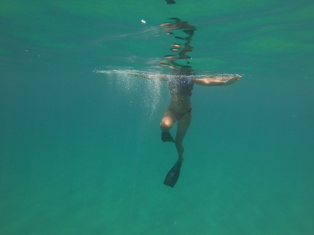 woman diving flippers swimming during daytime