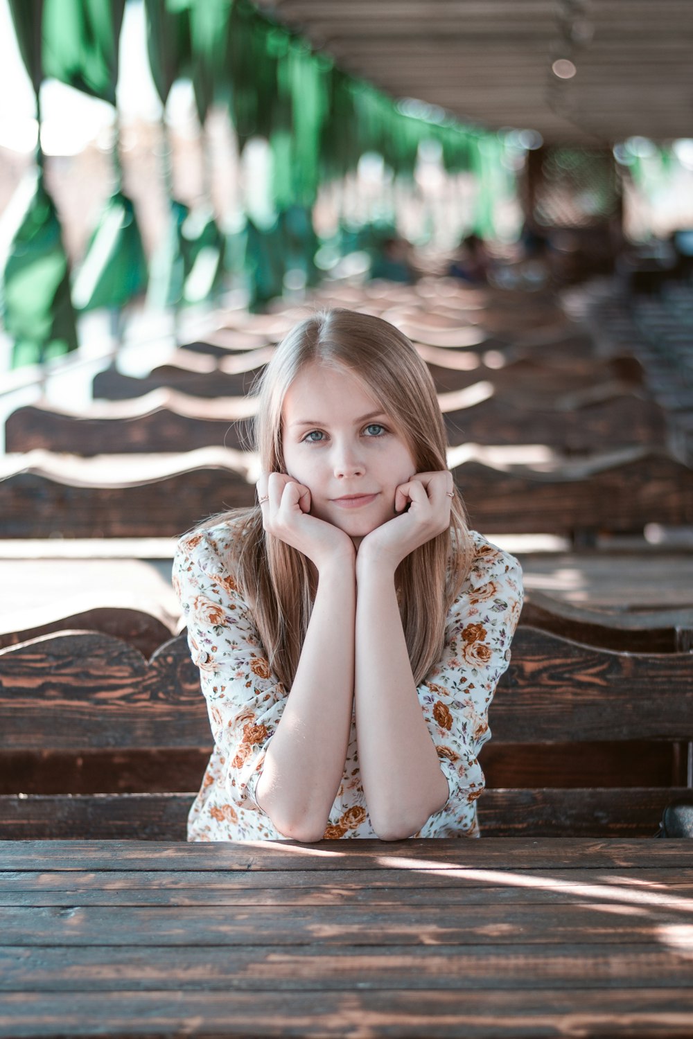 selective focus of woman resting hands on face while sitting