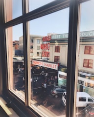 Window view showing nearby market streets bustling with activity.