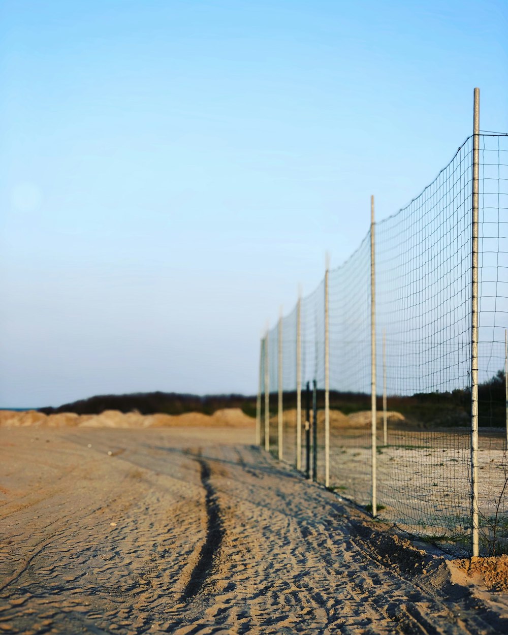 selective focus photography of metal fence