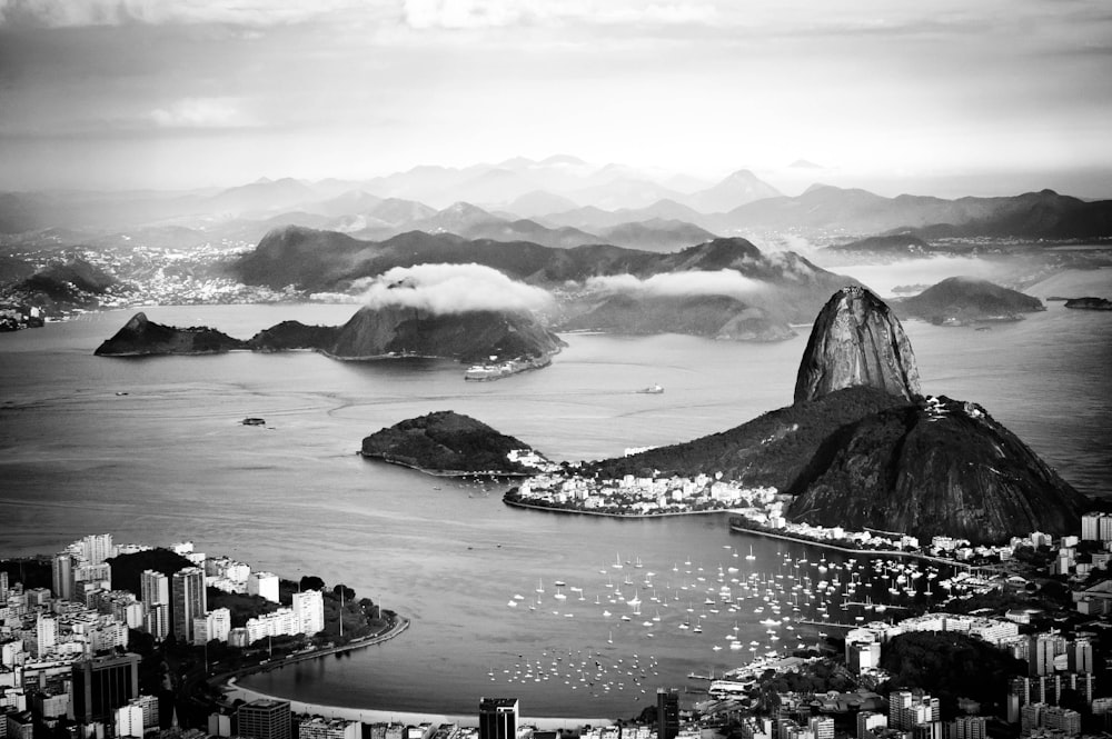 grayscale photography of island near body of water