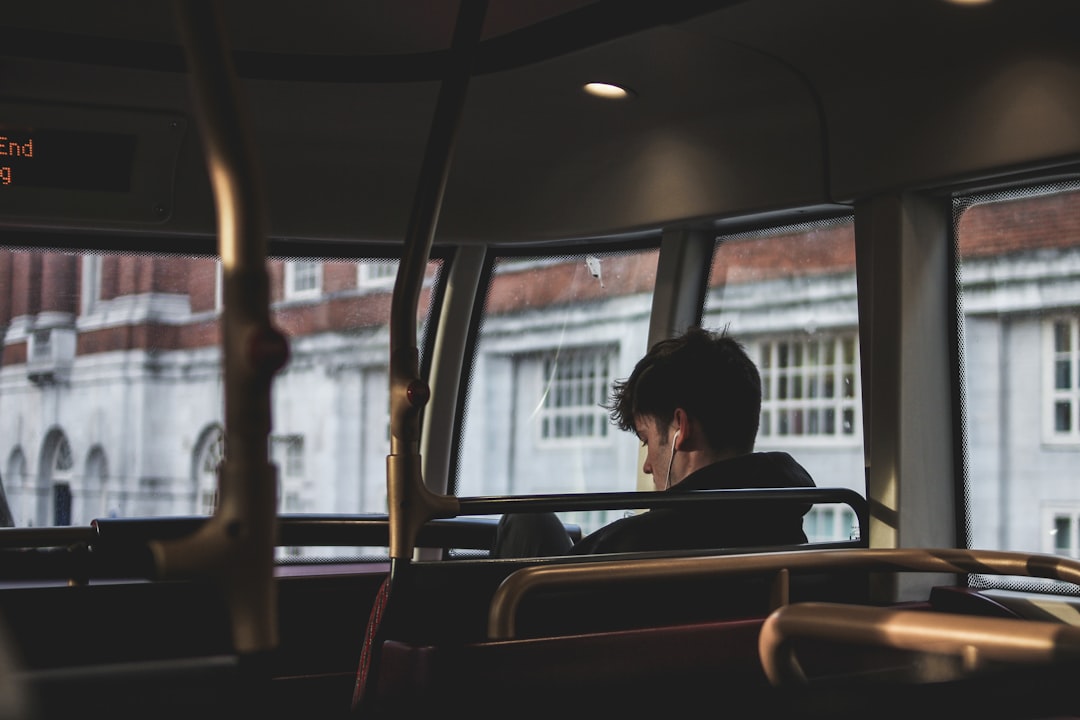 man inside bus using earphones, Bus ride