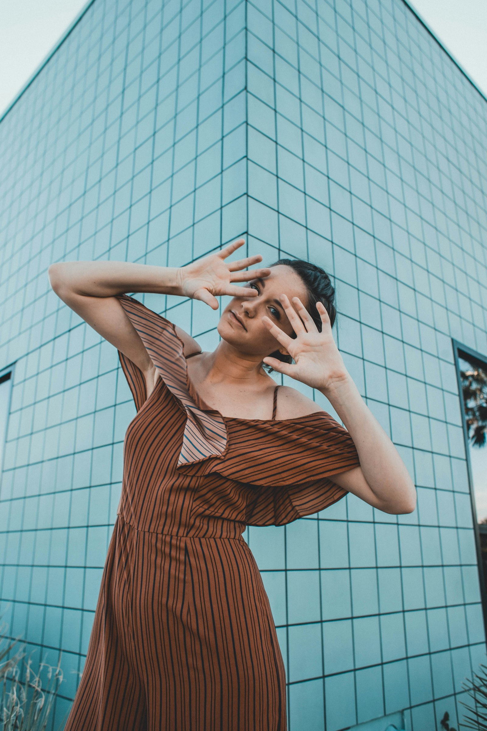 Canon EF 28mm F1.8 USM sample photo. Woman standing in-front building photography