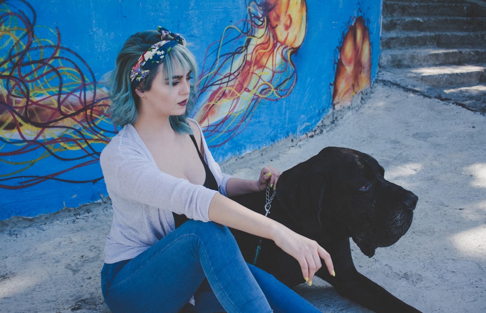 woman sitting beside dog