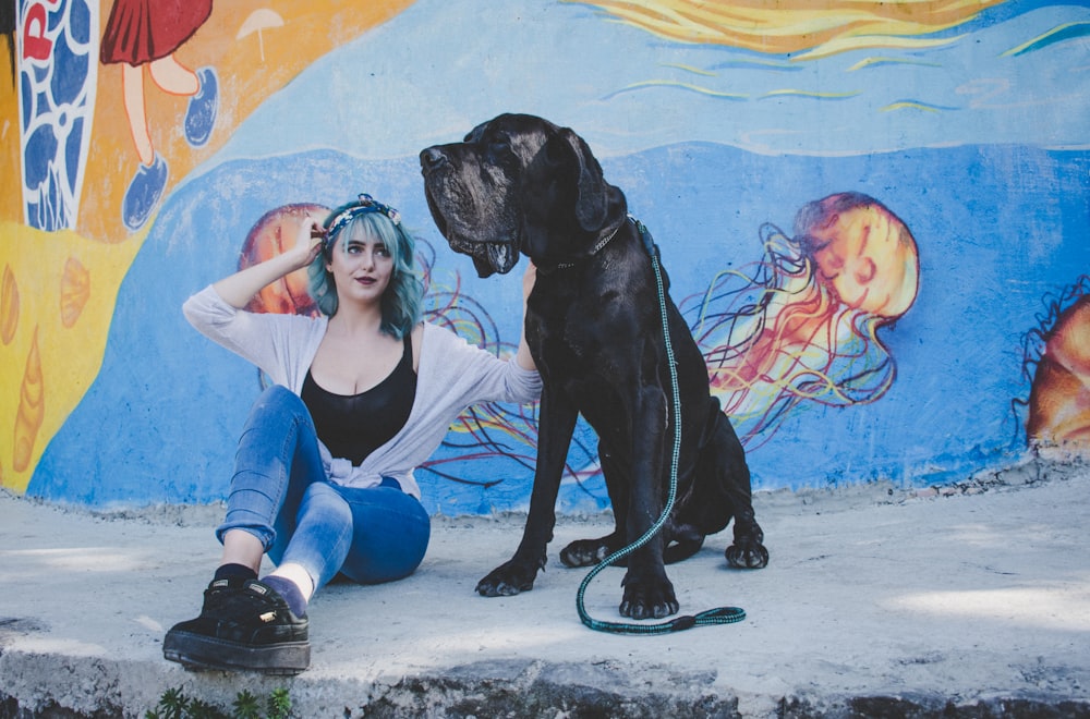 woman sitting on street with her dog