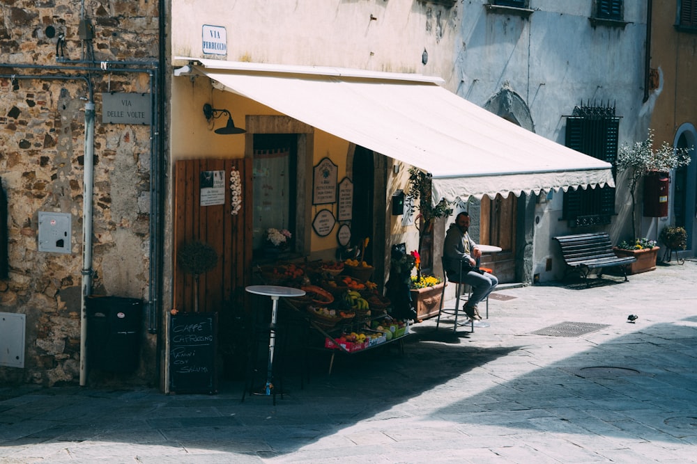 man sitting under awning during daytime