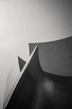 Monochrome close-up of a sleek, custom architectural finish highlighting sharp lines and textures.