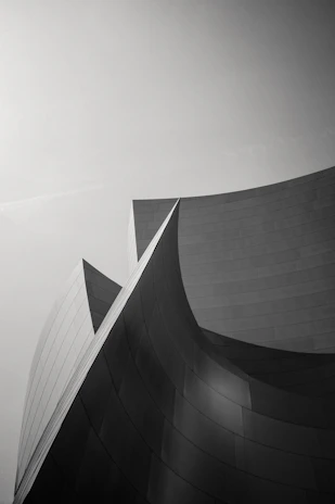Monochrome close-up of a sleek, custom architectural finish highlighting sharp lines and textures.