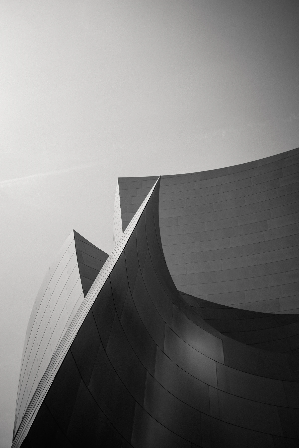 Modern building facade photographed from a dramatic low angle with clear sky