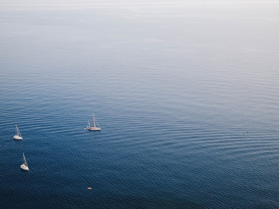 aerial photo of a body of water and fishing vessels