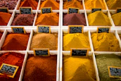 Stacks of packaged spices and dates arranged in a modern trading facility.