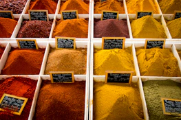 Stacks of packaged spices and dates arranged in a modern trading facility.