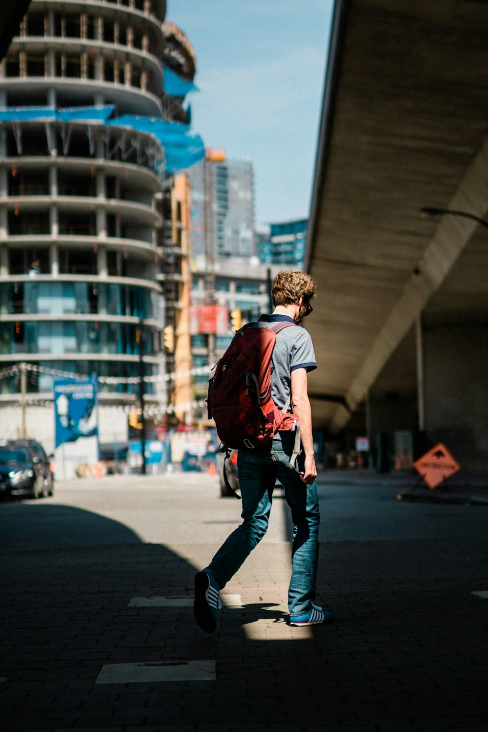 man walking on road near building