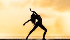 silhouette of woman making yoga pose