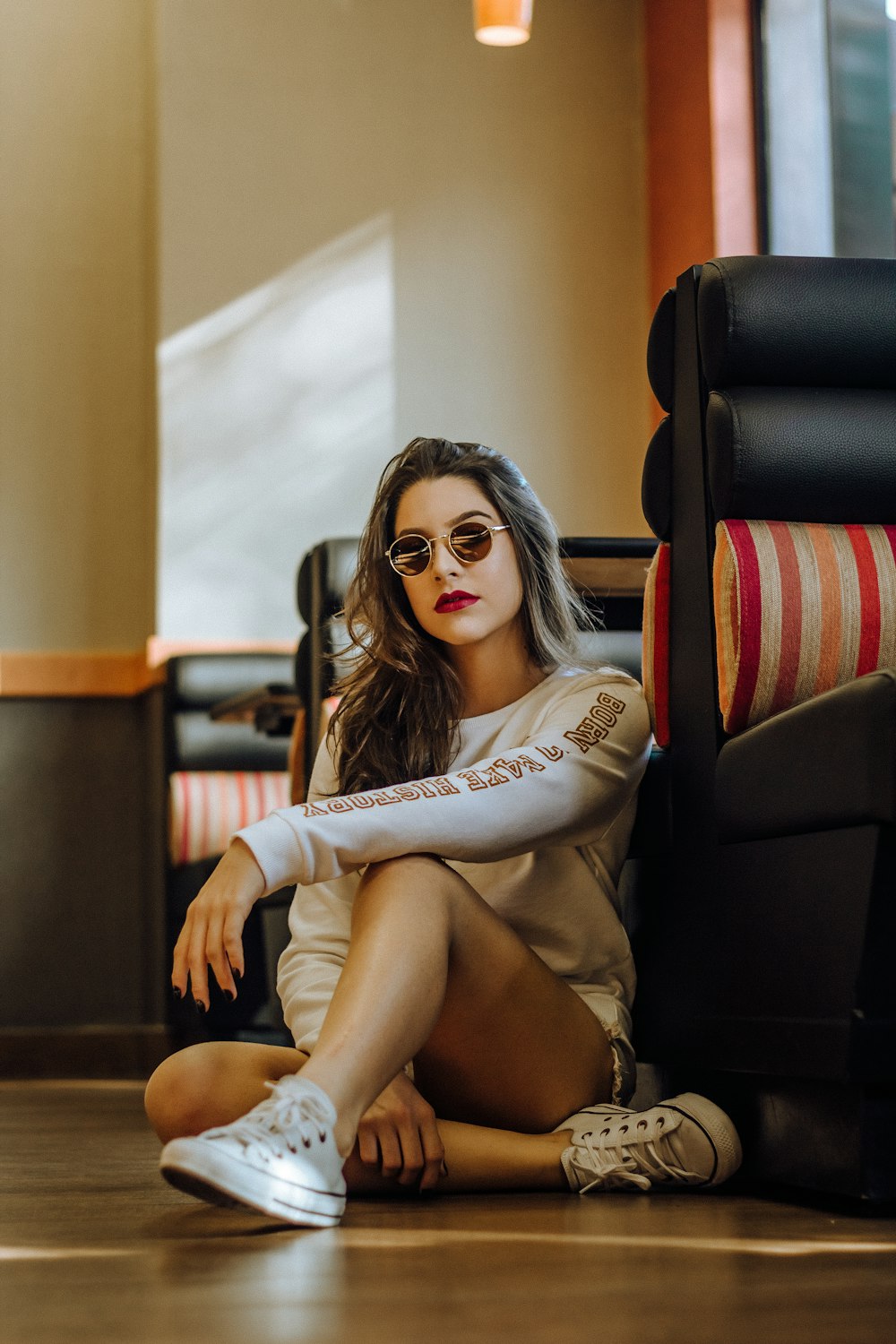 woman sitting near sofa with cross legs