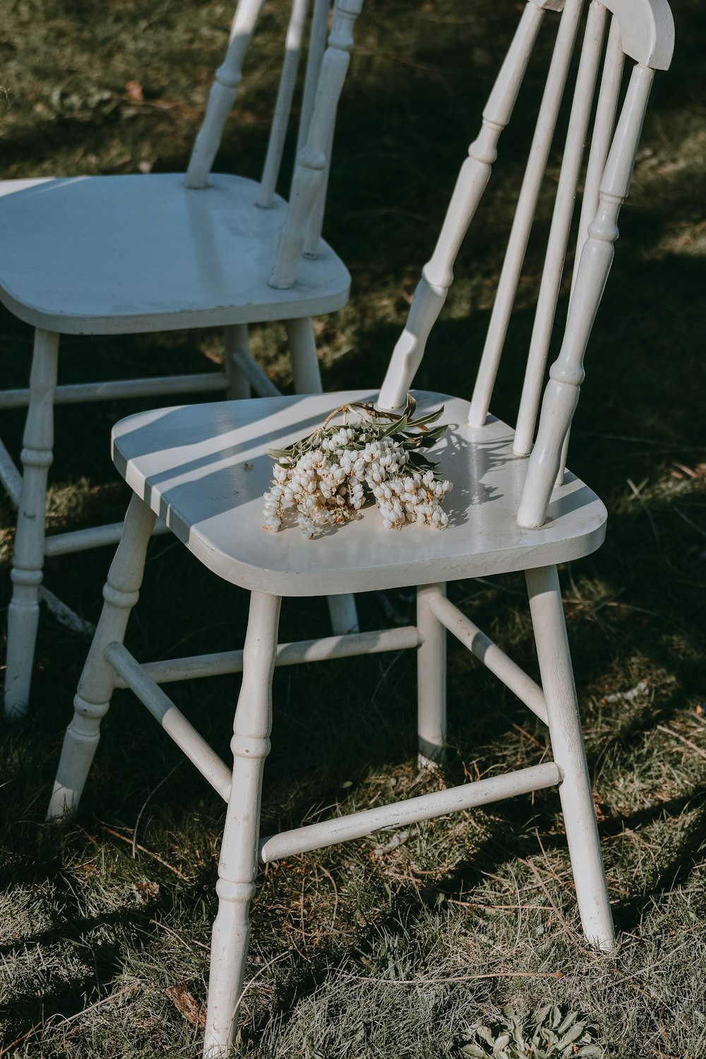 two white wooden armless chairs