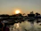 Traveler admiring a sunset over the river in Gambia, surrounded by lush nature.