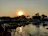 Traveler admiring a sunset over the river in Gambia, surrounded by lush nature.