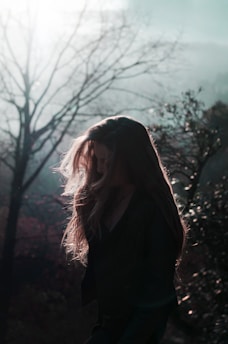 woman in black coat standing