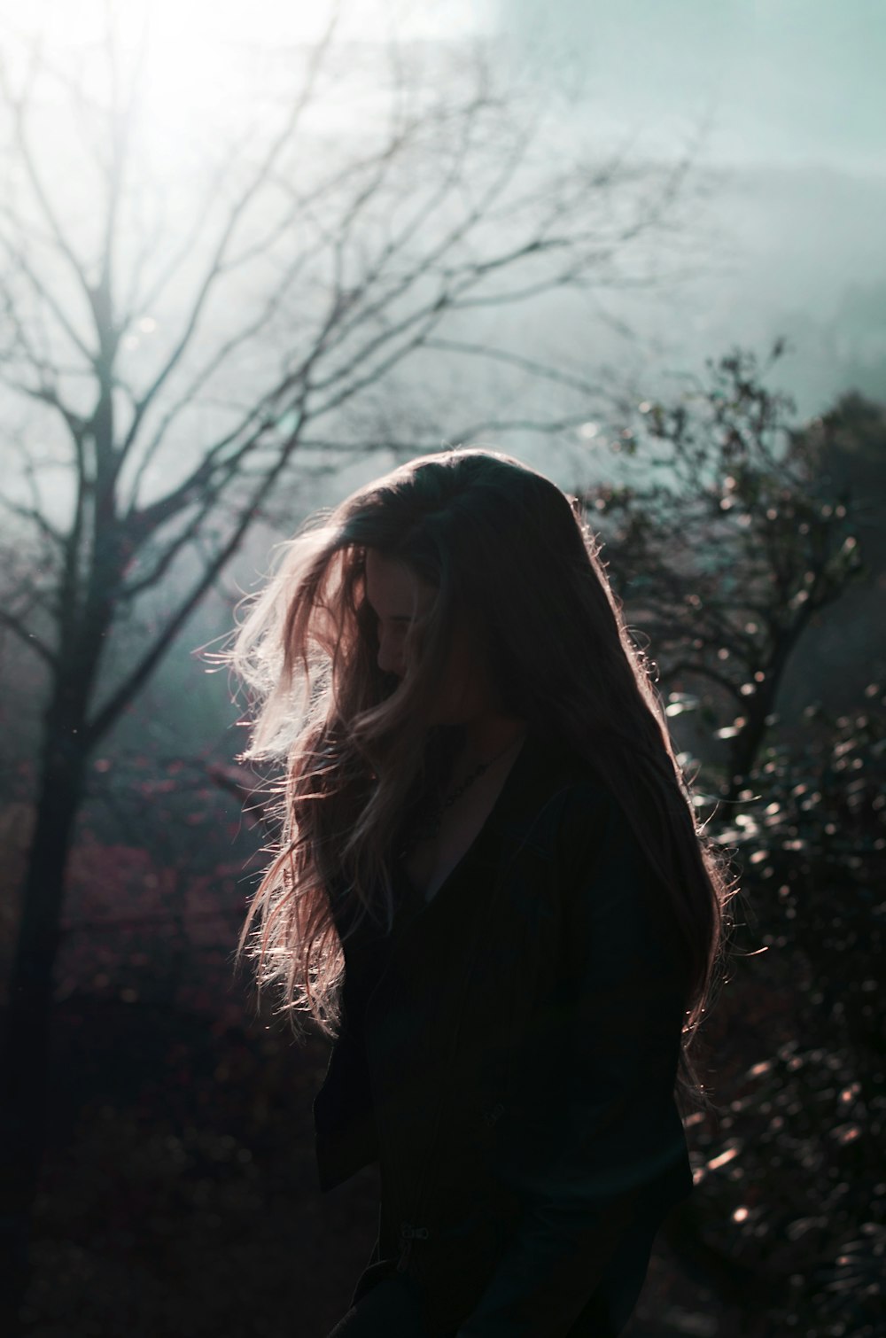 woman in black coat standing