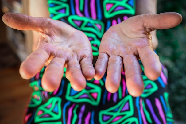 A pair of hands in a cool blue-to-purple gradient wrap, clenched into fists ready for a workout.