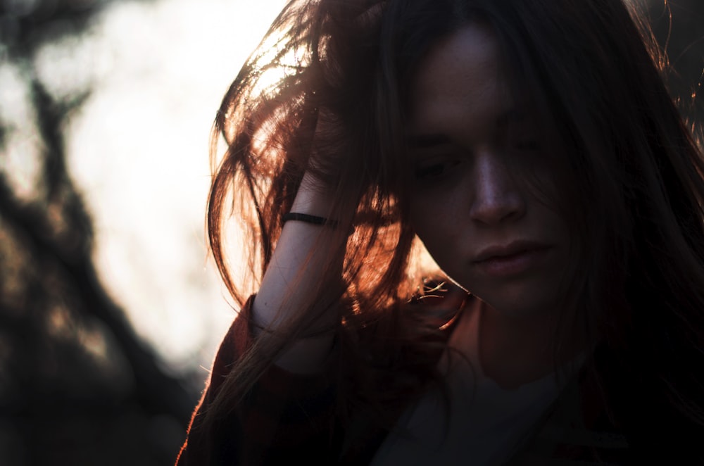 woman left hand on hair under sunset