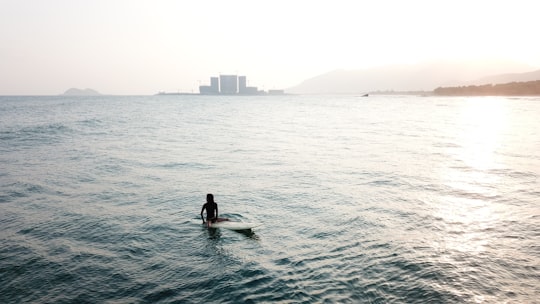 person on surfboard in Riyue Bay China