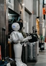 robot standing near luggage bags